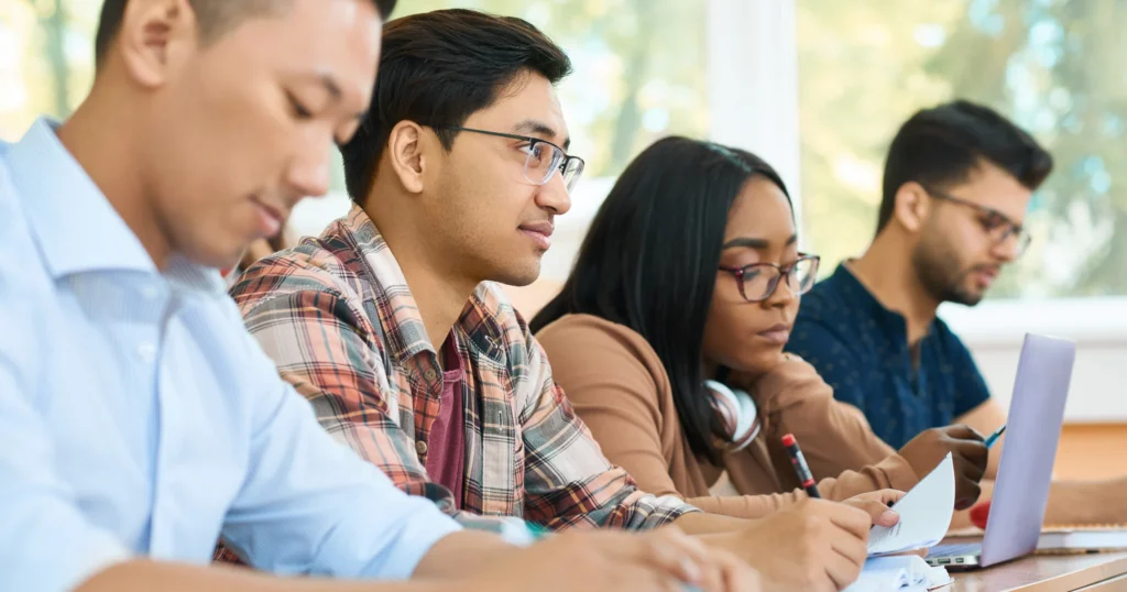 Concentrated students studying by a table